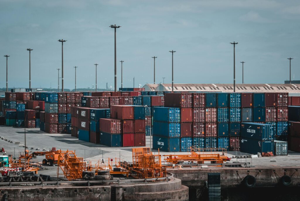 pexels-photo-1427541-1427541 Colorful cargo containers stacked at a busy industrial port, showcasing global trade.